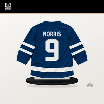 Josh Norris number 9 Buffalo Sabres jersey stand with included black base.