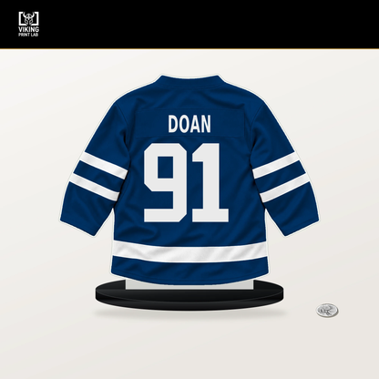 Josh Doan number 91 Buffalo Sabres jersey stand with included black base.