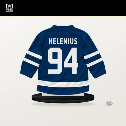 Konsta Helenius number 94 Buffalo Sabres jersey stand with included black base.