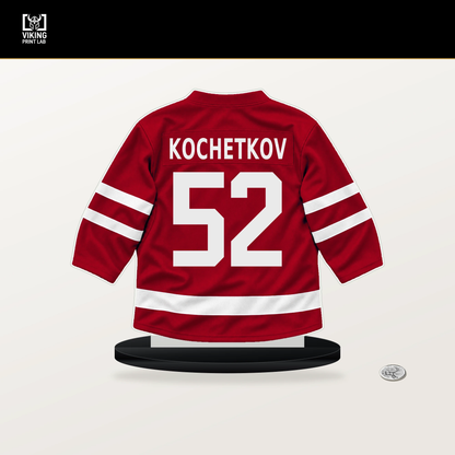 Pyotr Kochetkov number 52 Carolina Hurricanes jersey stand with included black base.