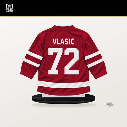 Alex Vlasic number 72 Chicago Blackhawks jersey stand with included black base.
