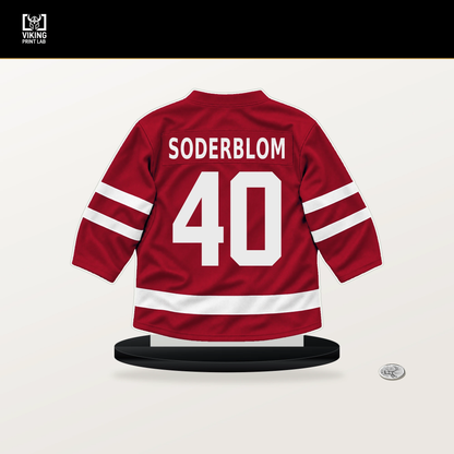 Arvid Soderblom number 40 Chicago Blackhawks jersey stand with included black base.