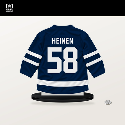 Danton Heinen number 58 Columbus Blue Jackets jersey stand with included black base.