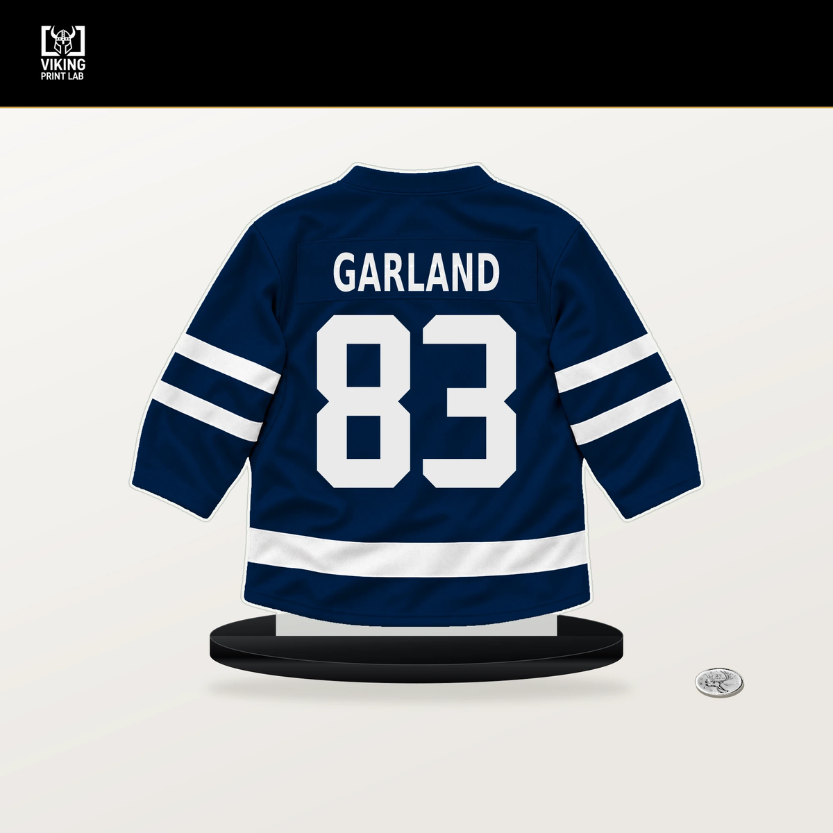 Conor Garland number 83 Columbus Blue Jackets jersey stand with included black base.