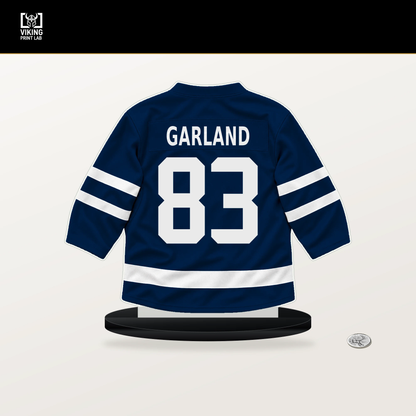 Conor Garland number 83 Columbus Blue Jackets jersey stand with included black base.