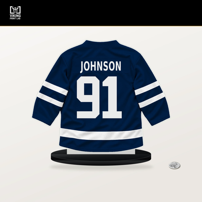 Kent Johnson number 91 Columbus Blue Jackets jersey stand with included black base.
