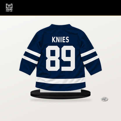 Matthew Knies number 89 Columbus Blue Jackets jersey stand with included black base.