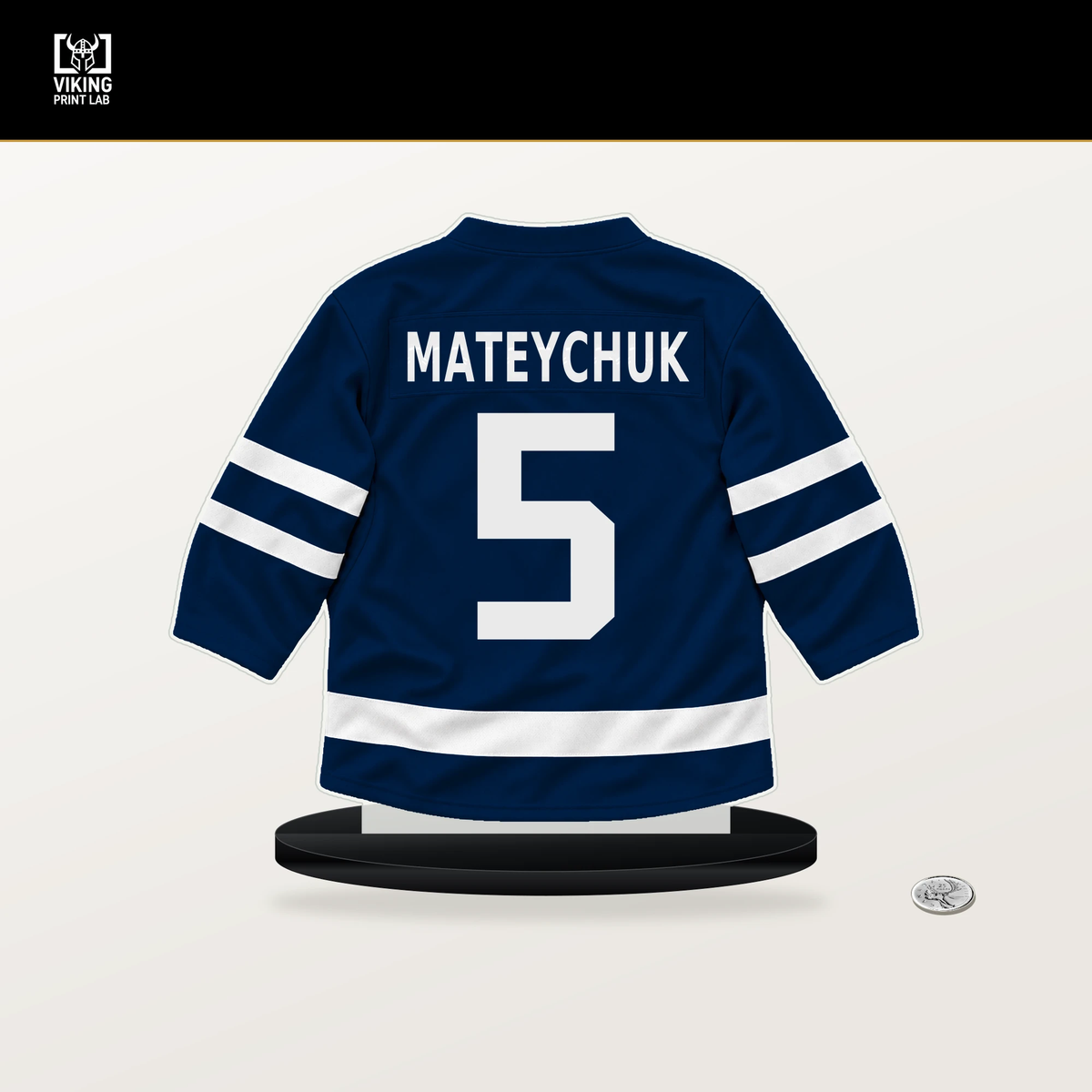 Denton Mateychuk number 5 Columbus Blue Jackets jersey stand with included black base.