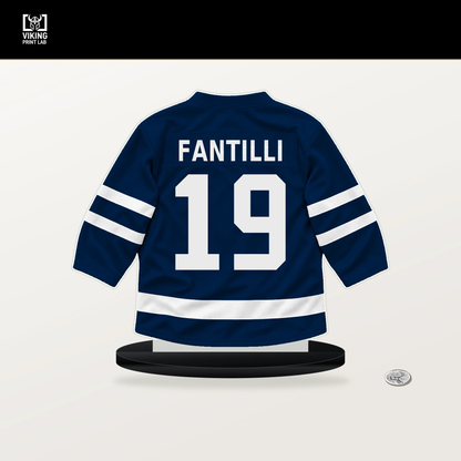 Adam Fantilli number 19 Columbus Blue Jackets jersey stand with included black base.