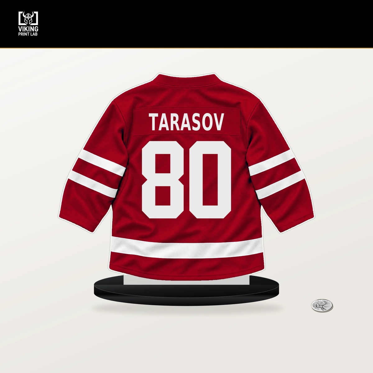 Daniil Tarasov number 80 Detroit Red Wings jersey stand with included black base.