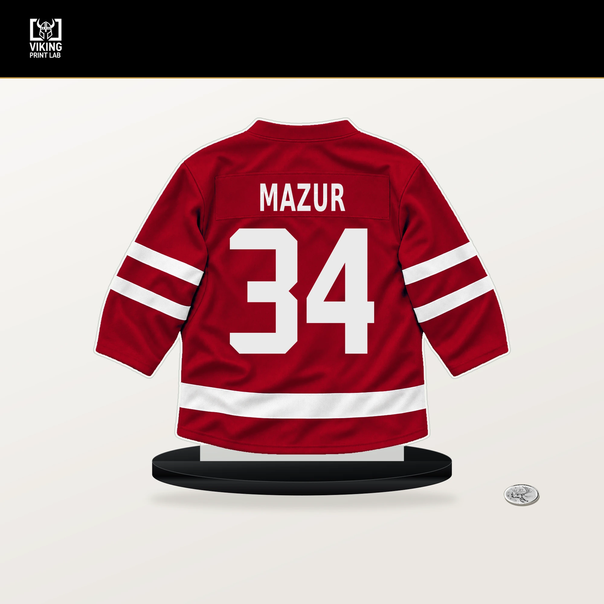 Carter Mazur number 34 Detroit Red Wings jersey stand with included black base.
