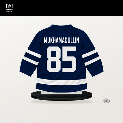 Shakir Mukhamadullin number 85 Edmonton Oilers jersey stand with included black base.