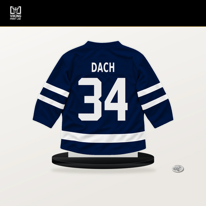 Colton Dach number 34 Edmonton Oilers jersey stand with included black base.