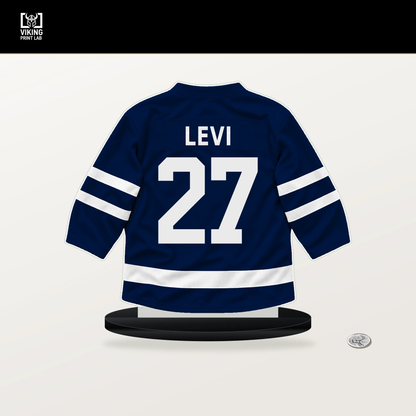Devon Levi number 27 Edmonton Oilers jersey stand with included black base.