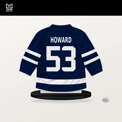 Isaac Howard number 53 Edmonton Oilers jersey stand with included black base.