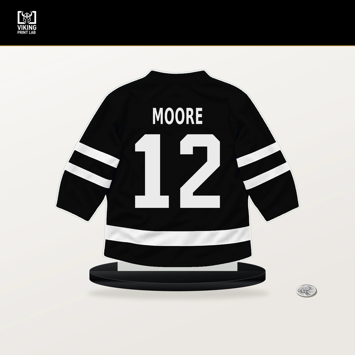 Trevor Moore number 12 Los Angeles Kings jersey stand with included black base.