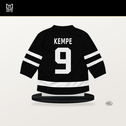 Adrian Kempe number 9 Los Angeles Kings jersey stand with included black base.