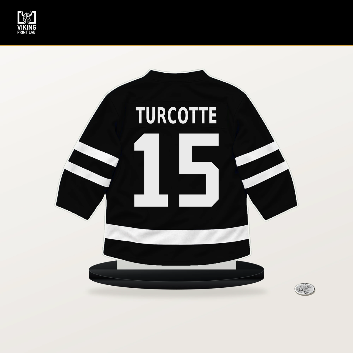 Alex Turcotte number 15 Los Angeles Kings jersey stand with included black base.