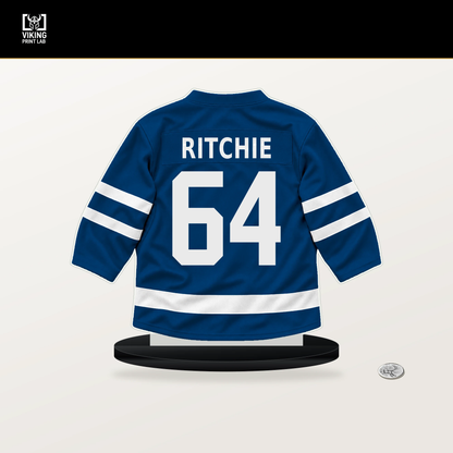 Calum Ritchie number 64 New York Islanders jersey stand with included black base.