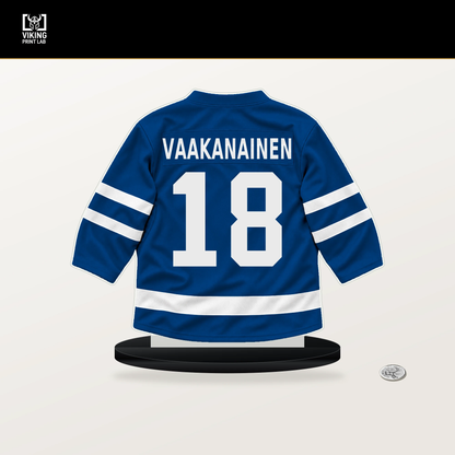 Urho Vaakanainen number 18 New York Rangers jersey stand with included black base.