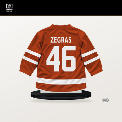 Trevor Zegras number 46 Philadelphia Flyers jersey stand with included black base.