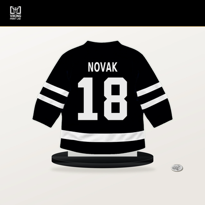 Tommy Novak number 18 Pittsburgh Penguins jersey stand with included black base.