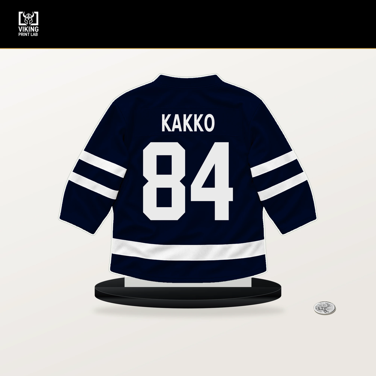 Kaapo Kakko number 84 Seattle Kraken jersey stand with included black base.