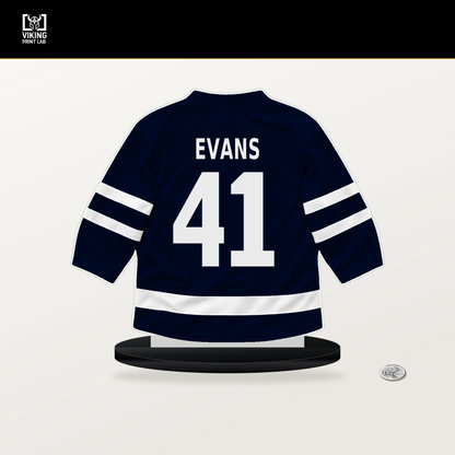 Ryker Evans number 41 Seattle Kraken jersey stand with included black base.