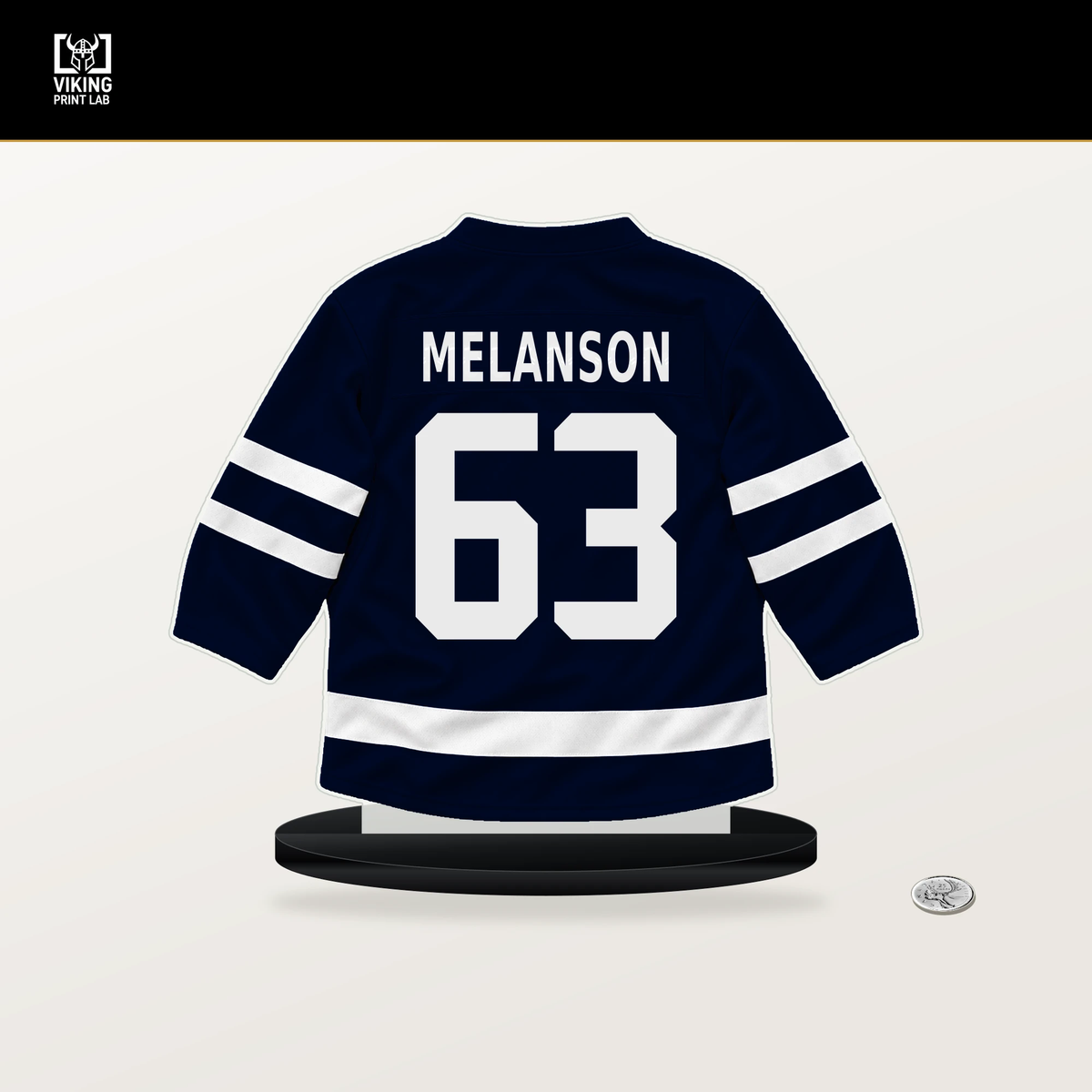 Jacob Melanson number 63 Seattle Kraken jersey stand with included black base.
