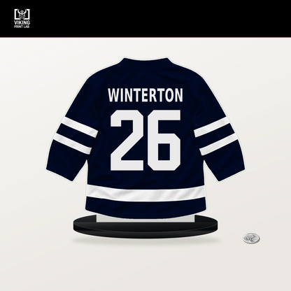 Ryan Winterton number 26 Seattle Kraken jersey stand with included black base.