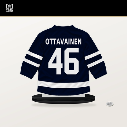 Ville Ottavainen number 46 Seattle Kraken jersey stand with included black base.