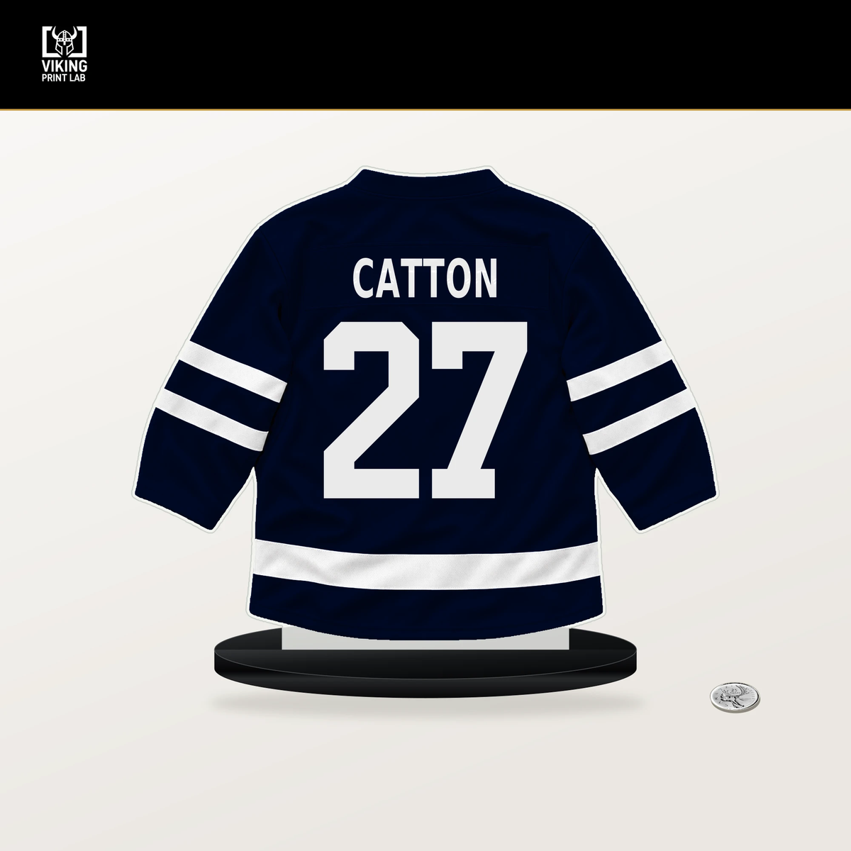 Berkly Catton number 27 Seattle Kraken jersey stand with included black base.
