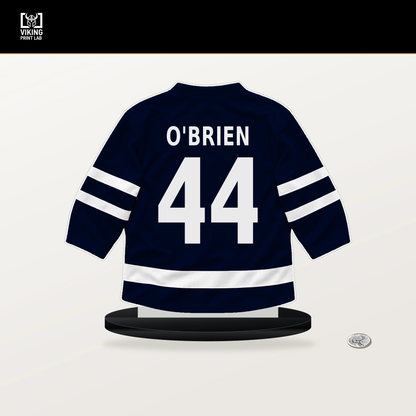 Jake O'Brien number 44 Seattle Kraken jersey stand with included black base.