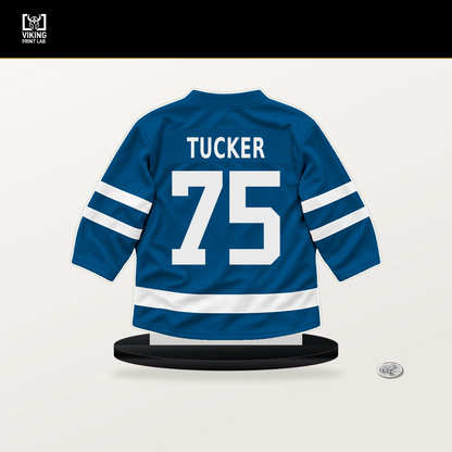 Tyler Tucker number 75 St. Louis Blues jersey stand with included black base.