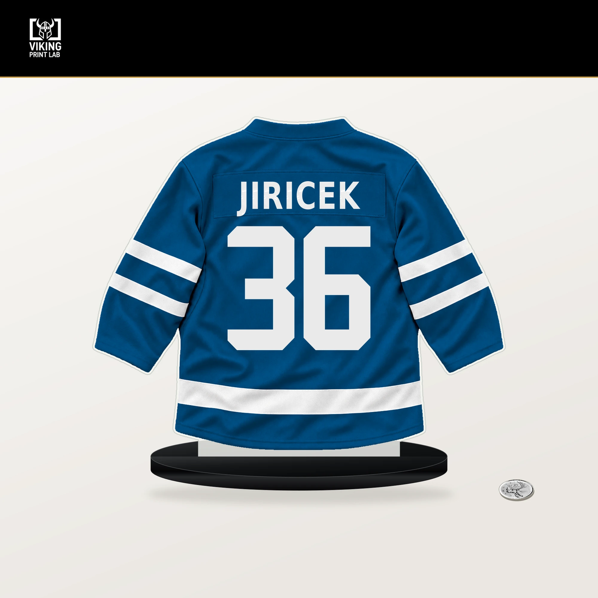 Adam Jiricek number 36 St. Louis Blues jersey stand with included black base.