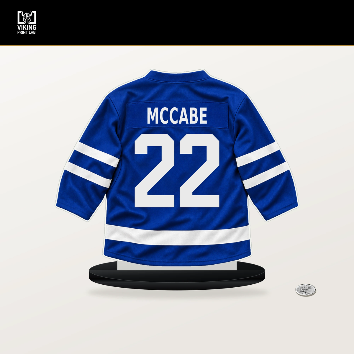 Jake McCabe number 22 Toronto Maple Leafs jersey stand with included black base.
