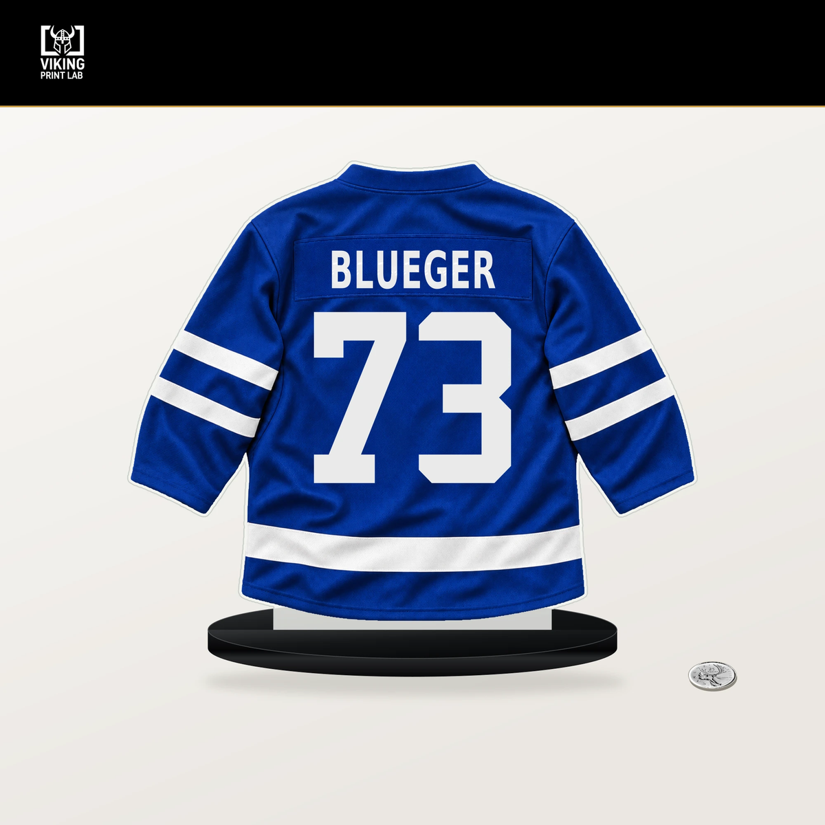 Teddy Blueger number 73 Toronto Maple Leafs jersey stand with included black base.