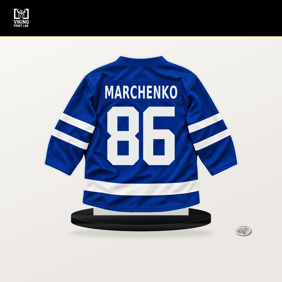 Kirill Marchenko number 86 Toronto Maple Leafs jersey stand with included black base.