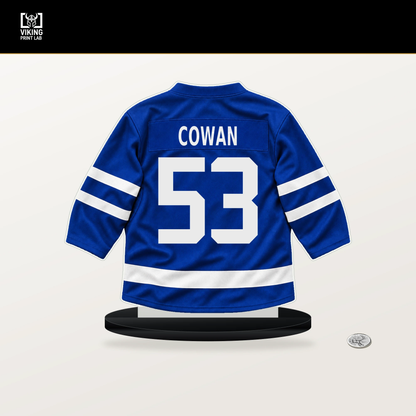 Easton Cowan number 53 Toronto Maple Leafs jersey stand with included black base.