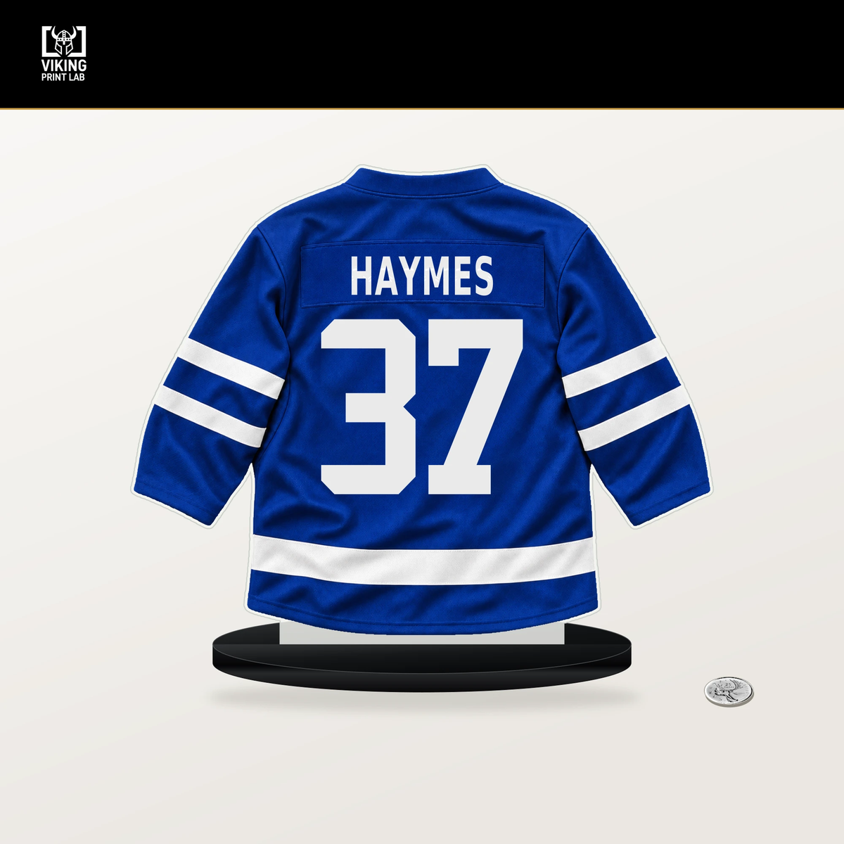 Luke Haymes number 37 Toronto Maple Leafs jersey stand with included black base.