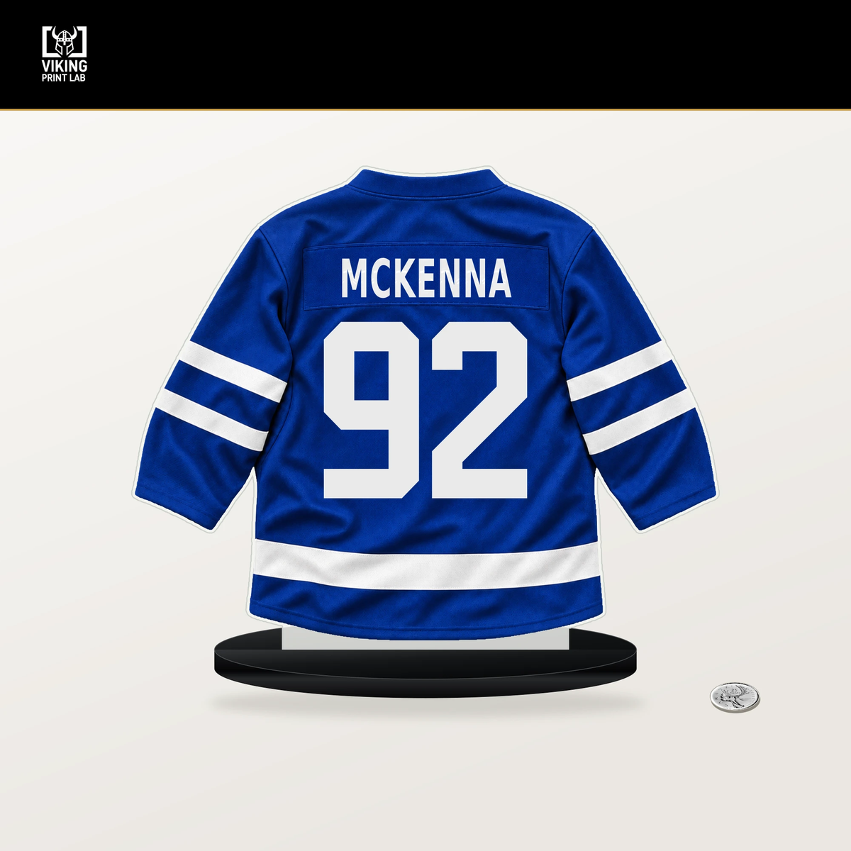 Gavin McKenna number 92 Toronto Maple Leafs jersey stand with included black base.