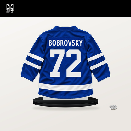 Sergei Bobrovsky number 72 Toronto Maple Leafs jersey stand with included black base.