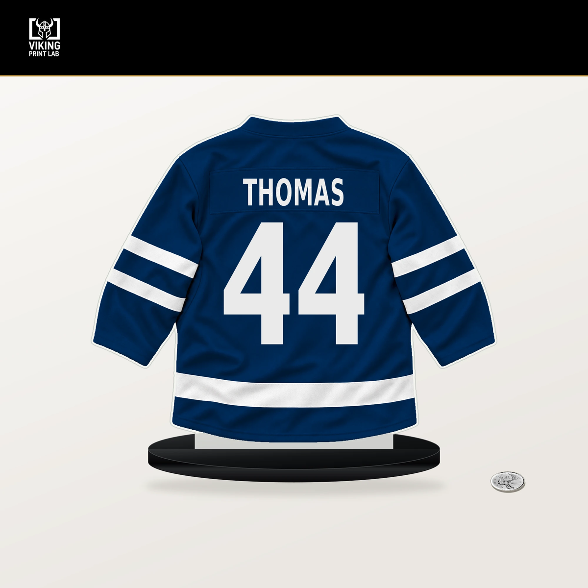 Akil Thomas number 44 Vancouver Canucks jersey stand with included black base.
