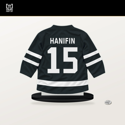 Noah Hanifin number 15 Vegas Golden Knights jersey stand with included black base.