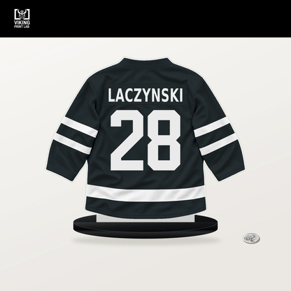 Tanner Laczynski number 28 Vegas Golden Knights jersey stand with included black base.