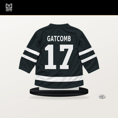 Marc Gatcomb number 17 Vegas Golden Knights jersey stand with included black base.