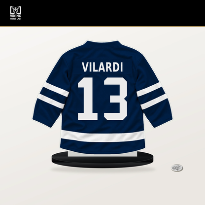 Gabriel Vilardi number 13 Winnipeg Jets jersey stand with included black base.