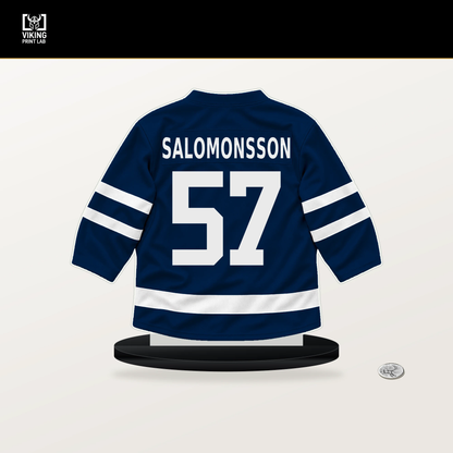 Elias Salomonsson number 57 Winnipeg Jets jersey stand with included black base.