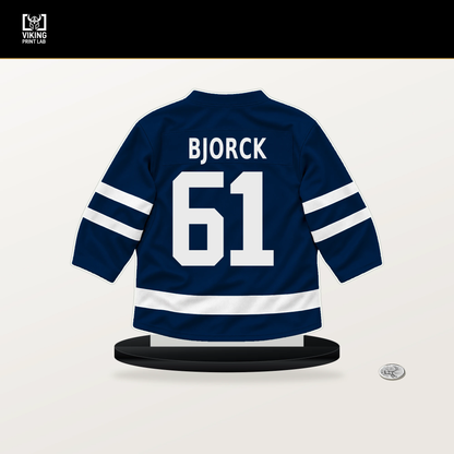Viggo Bjorck number 61 Winnipeg Jets jersey stand with included black base.