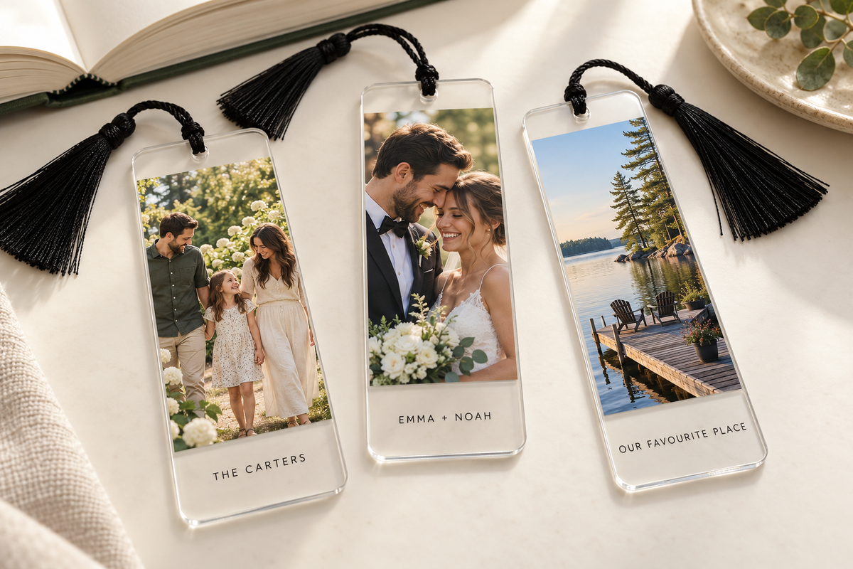 Digital mockup. Three clear acrylic photo bookmark concepts featuring family, wedding and lakeside photographs with black tassels. Current purchase option: frosted acrylic with black tassel.